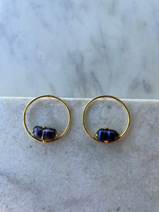 Gold circle earring with purple pearl